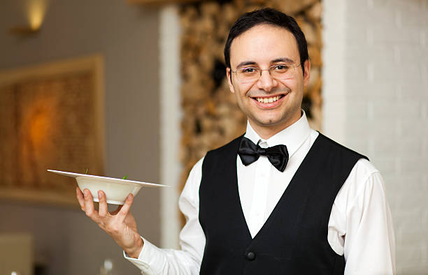 istock Waiter holding dish in a restaurant 516033380
