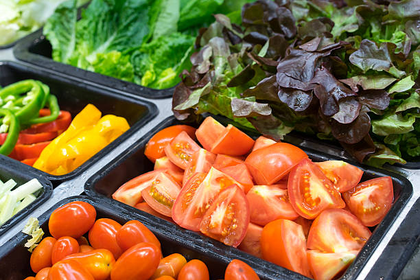 Tomatoes and other vegetables in salad trays Tomatoes and other vegetables in salad trays food service occupation food and drink industry party buffet stock pictures, royalty-free photos & images