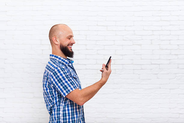 istock Casual Bearded Man Using Cell Smart Phone Happy Smile 516034600
