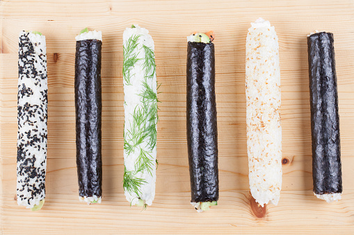 Homemade sushi rolls on cutting board