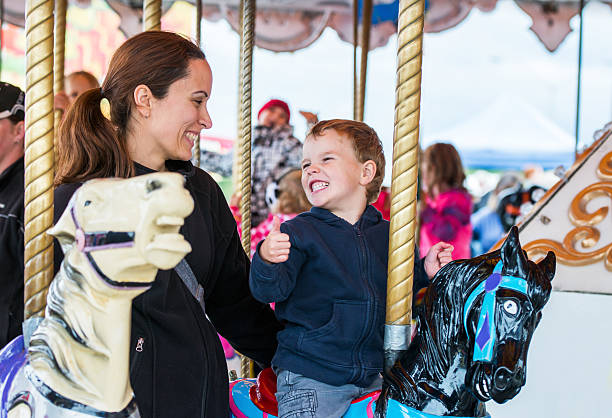 istock Boy and Mother on Carousel Smiling at Each Other 516036341