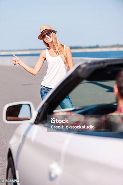 Woman Hitching A Ride Stock Photo - Download Image Now - Adult, Adventure, Arms Outstretched