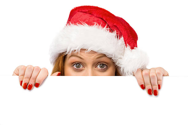 istock Festive redhead smiling at camera holding poster 516036707