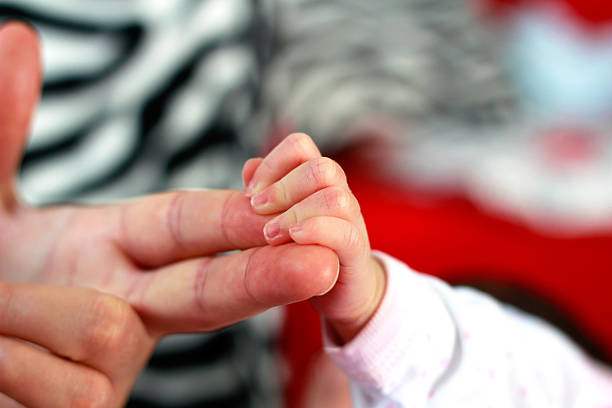 istock Newborn holding mother's finger 516036915