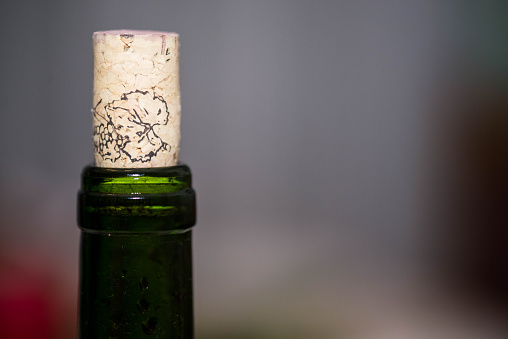 green bottle with cork, blurred background