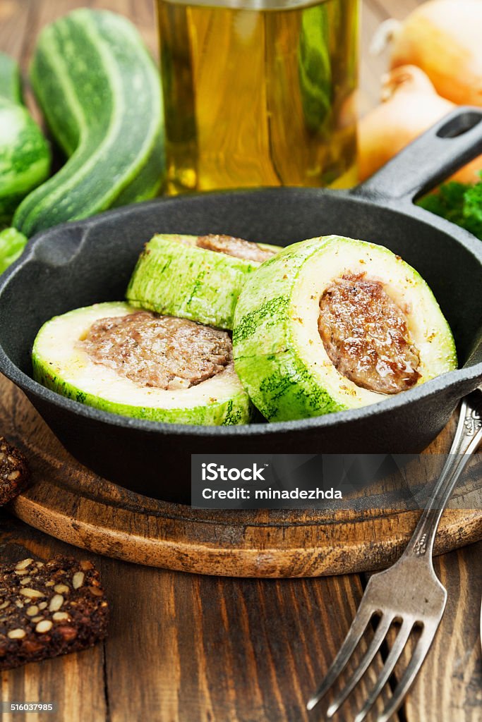 Zucchini with meat Zucchini with meat in the frying pan on the table Baked Stock Photo