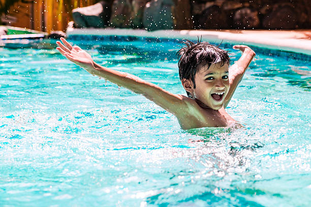 istock Young boy child swimming pool having fun leisure activity arms 516038276