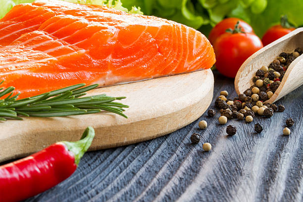 istock Fresh raw salmon fillet on cutting board. 516039858