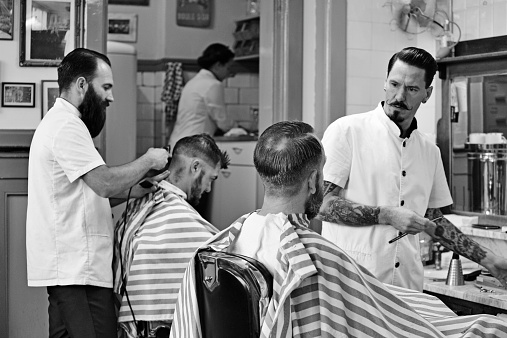 barbers working on customers