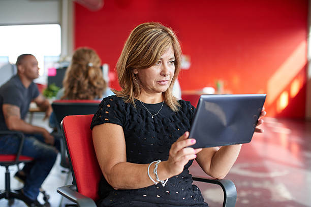 istock Confident female designer working on a digital tablet in red 516040240