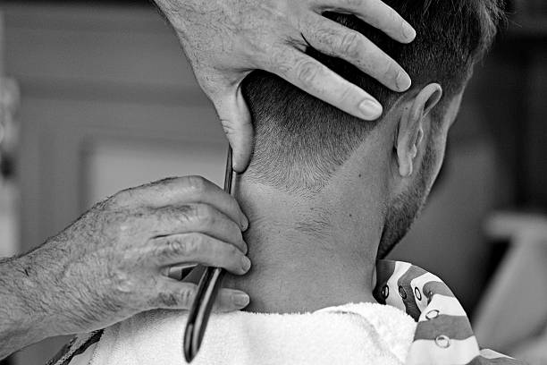 barber razor shaving back of customers head