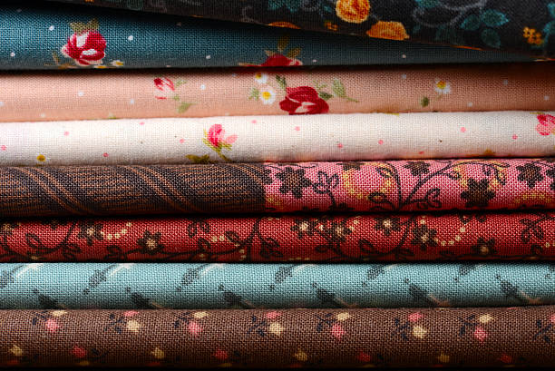istock heap of cloth fabrics on wooden table 516041207