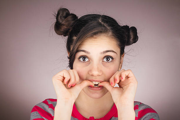 istock Worried young girl biting nail 516042082