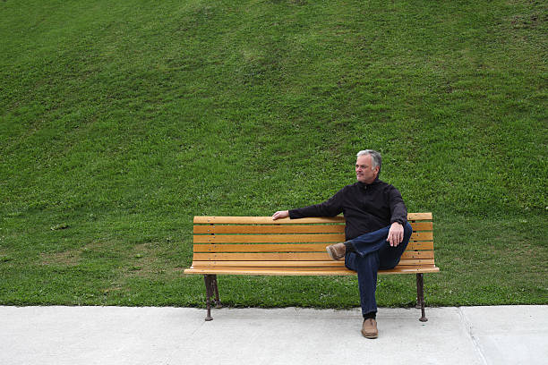 istock Mature man sitting on park bench. 516042547