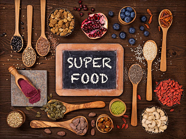 Super foods in spoons and bowls Super foods in spoons and bowls on a wooden background antioxidant stock pictures, royalty-free photos & images