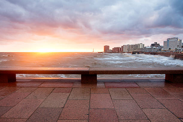 Sunset over water and skyline stock photo