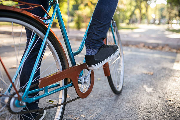 istock Young hipster man riding a bicycle focus on his shoes 516047150
