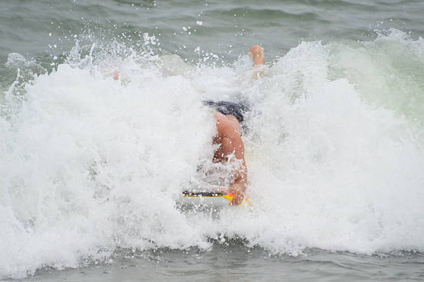 istock Man Boogie Boarding In The Ocean With Wave Crashing 516061023