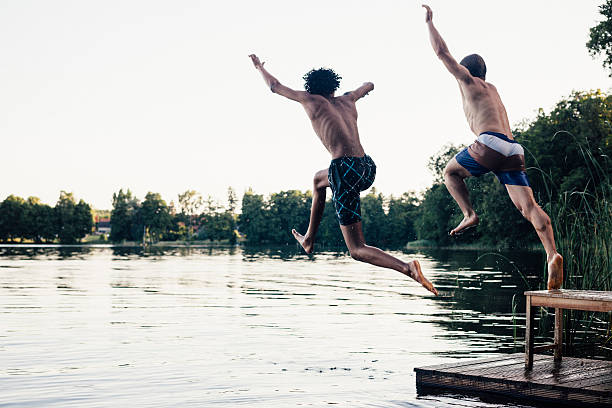 Friends Diving Into Water
