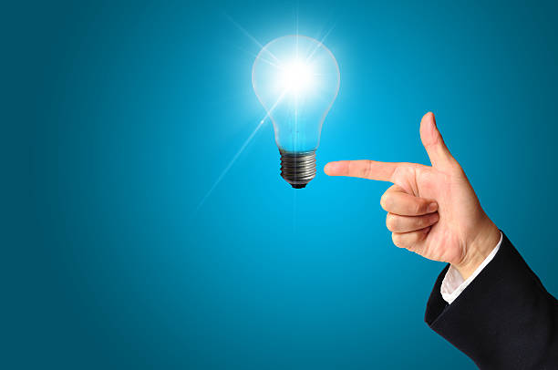 Business man touching light of idea