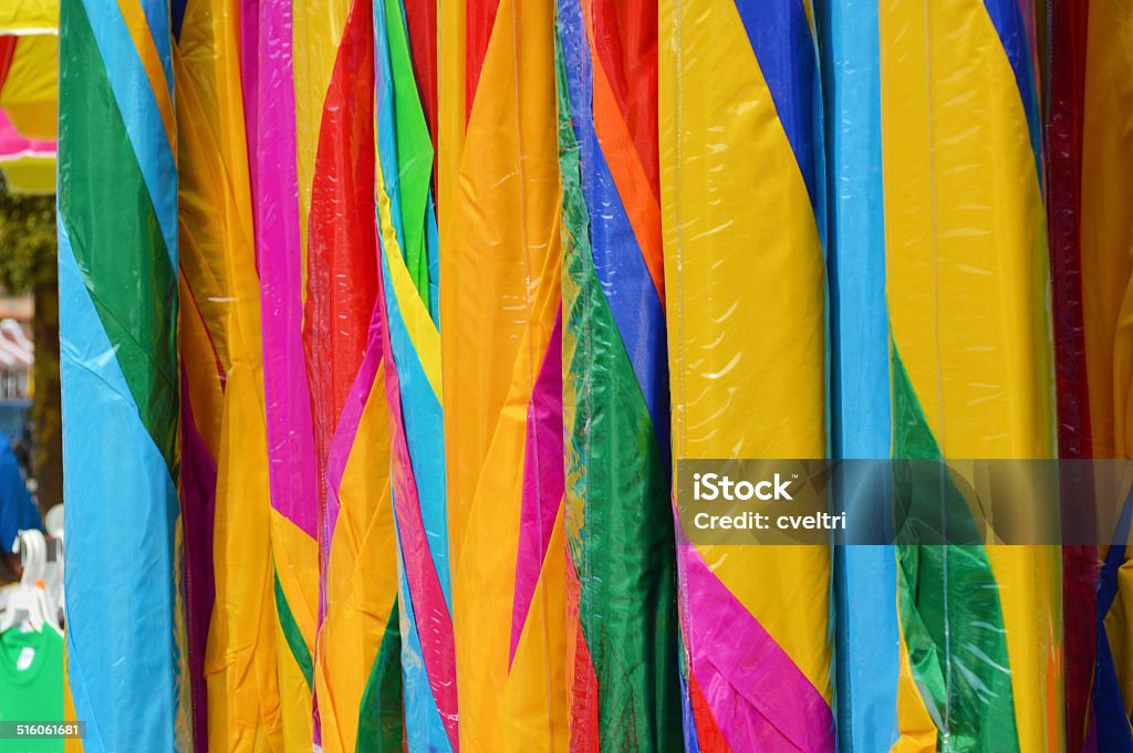 Colorful Closed Umbrellas For Sale Colorful umbrellas lined up outside in a row. Horizontal Stock Photo