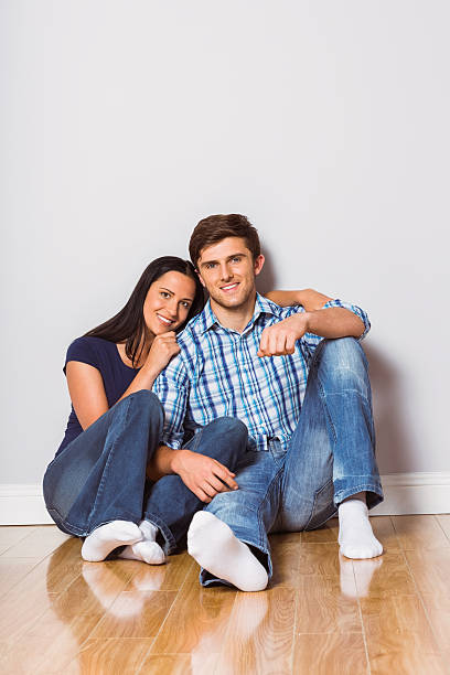 istock Young couple sitting on floor 516061911