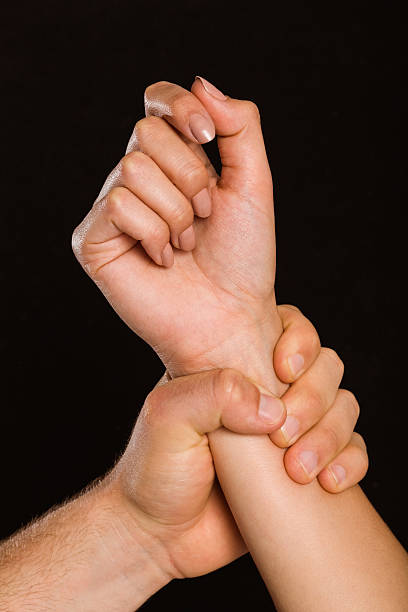 istock Male hand grabbing female wrist 516062155