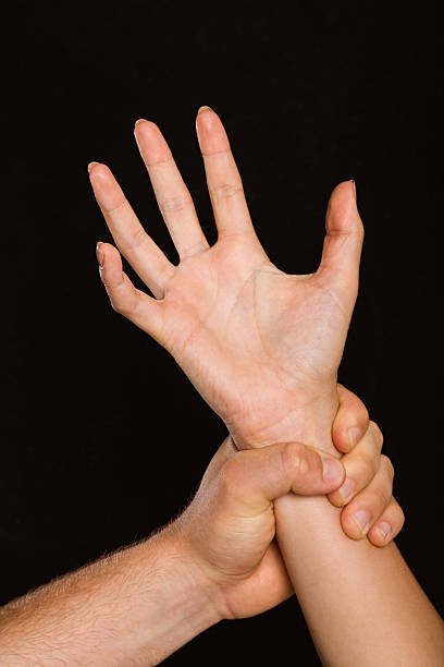 istock Male hand grabbing female wrist 516062243