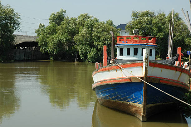 istock Fishinig Boat Lays on the River 516063479