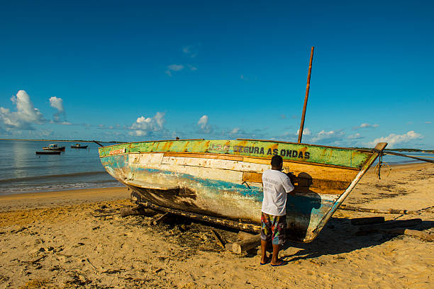 человек и гребная лодка - skiff nautical vessel rustic old стоковые фото и изображения