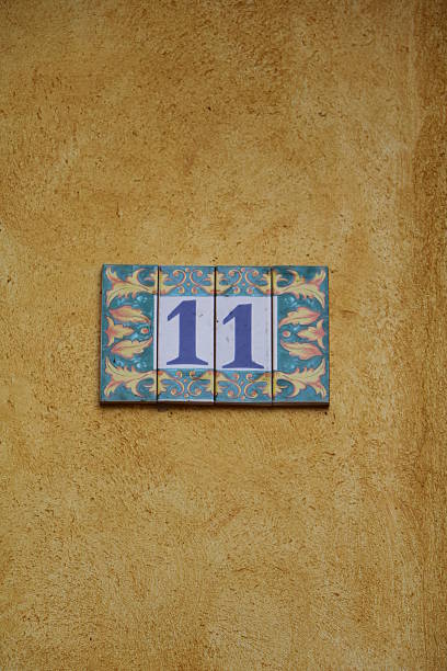 istock house number eleven at a yellow house wall 516064076