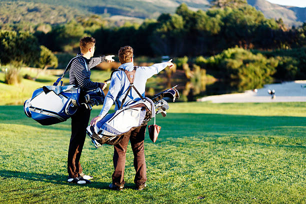 istock Two young golfers point out something on the course 516064695