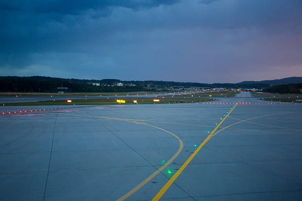 istock Landing lights at night on airport runway 516065503