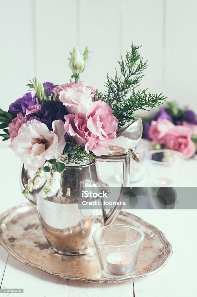 elegant floral decor Summer bouquet of purple and pink eustomas in an antique coffee pot on a white wooden board, vintage style, holiday and wedding elegant floral decor Arrangement Stock Photo