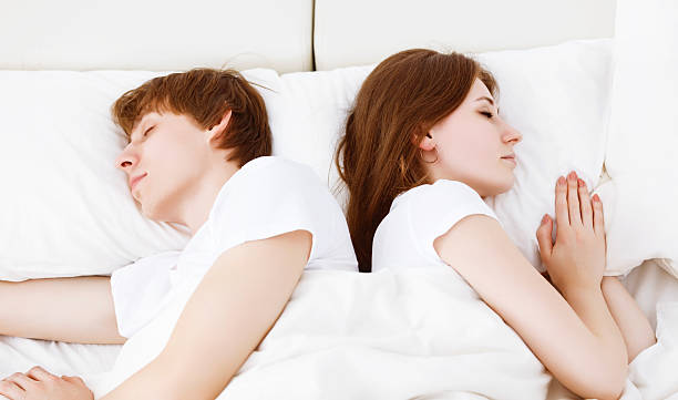 istock Upset couple having marital problems a disagreement and sleeping 516066266