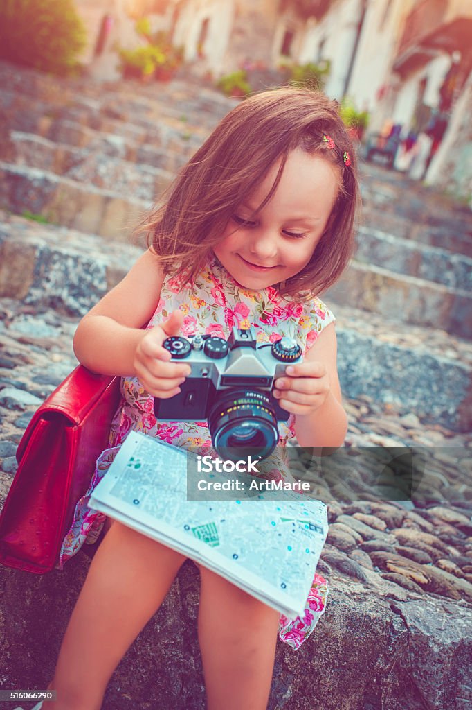 Little tourist Little girl with a map land a camera traveling in Europe 2-3 Years Stock Photo