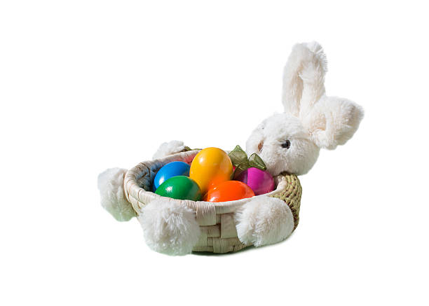 istock Easter Bunny with colored eggs in the basket isolated 516066738