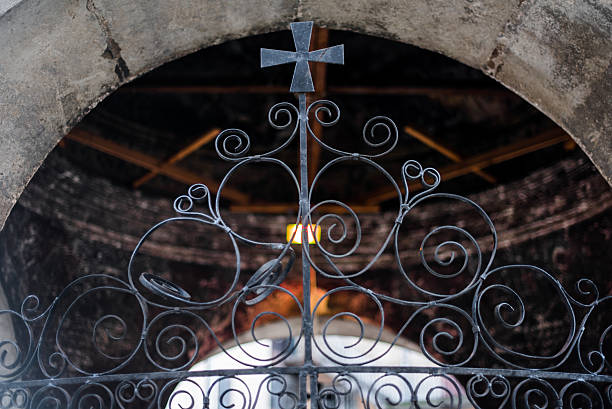 istock Forged black lattice with cross on the chapel 516067418