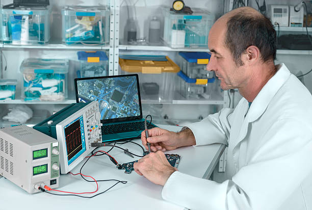 Senior male tech is working in hardware repair facility