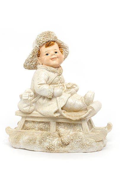 istock figurine a boy on a sled isolated on white 516068202