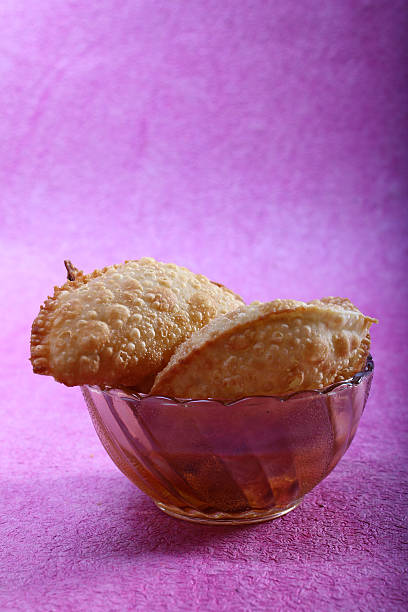 Indian traditional snacks gujiya indian sweet snacks gujia in bowl, holi festival food rawa island stock pictures, royalty-free photos & images