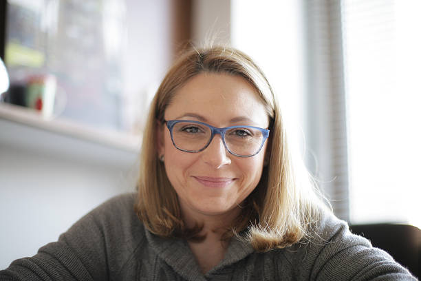 istock Smiling young woman with glasses 516071640