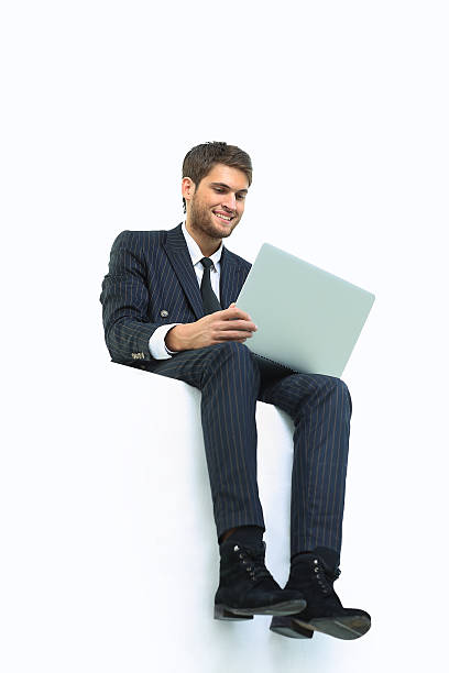 istock handsome young business man sitting on a white top 516073162