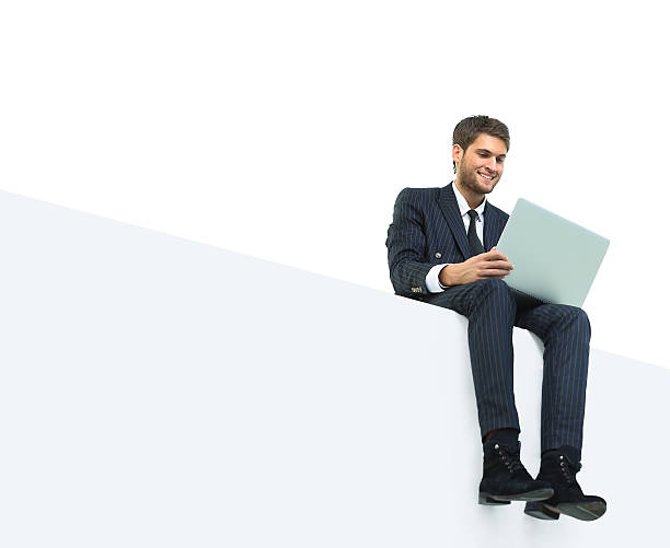 istock handsome young business man sitting on a white top 516073198