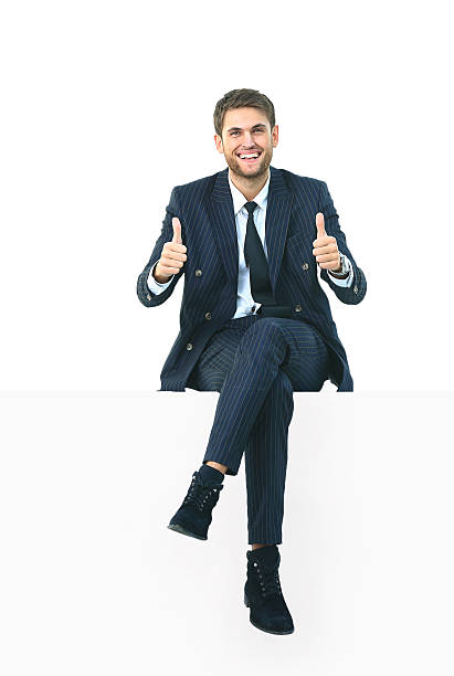 istock handsome young business man sitting on a white top 516073262