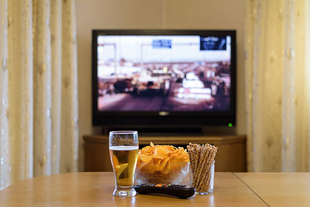 istock setup of TV (television) and snacks in home 516074062