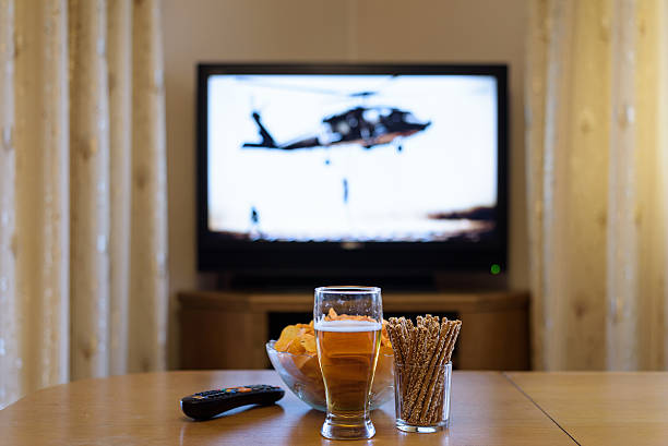 istock setup of TV (television) and snacks in home 516074300