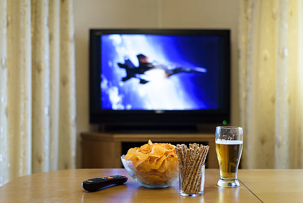 istock setup of TV (television) and snacks in home 516074546