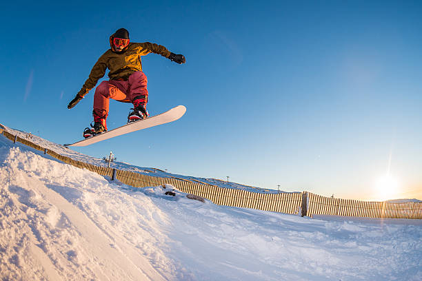 istock Snowboarder jumping against blue sky 516074676