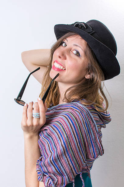 istock Happy girl posing with a hat and sunglasses 516076564